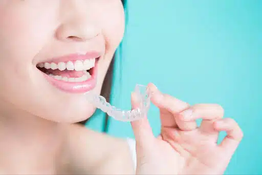 patient removing tray while wearing clear aligners